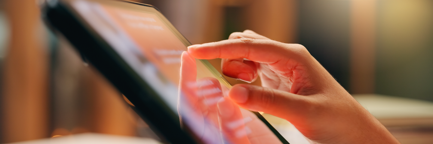 Hands holding a tablet with a content feed. UMLAC News: institutional communications from the university.